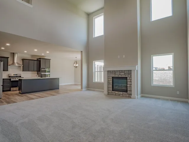 a view of an empty room with a fireplace and a window