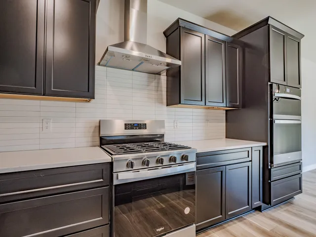 a kitchen with stainless steel appliances granite countertop a stove and a refrigerator