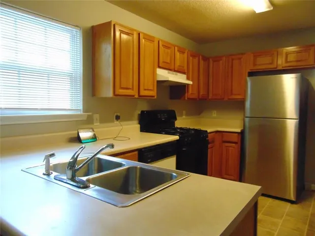 a kitchen with a refrigerator and a sink