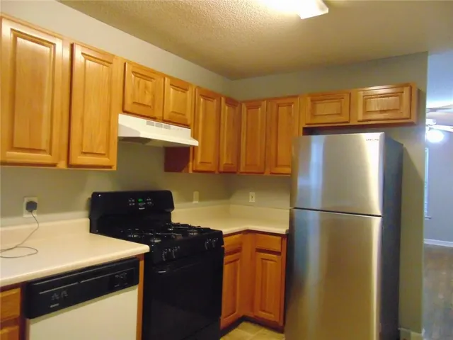 a kitchen with a refrigerator and a sink