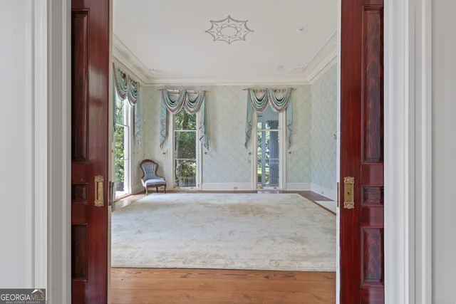a view of an entryway with wooden floor