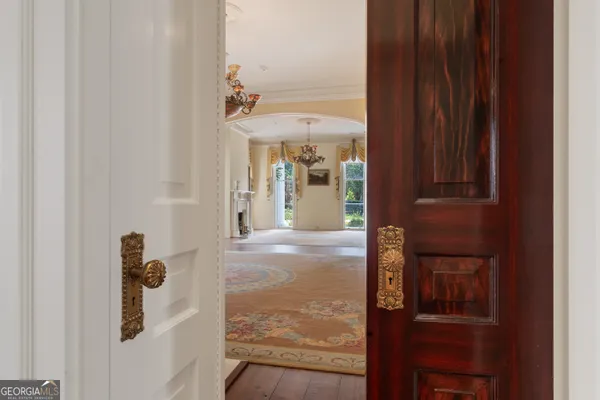 a view of an empty room with a fireplace and a window