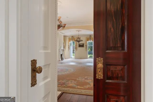 a view of an empty room with a fireplace and a window