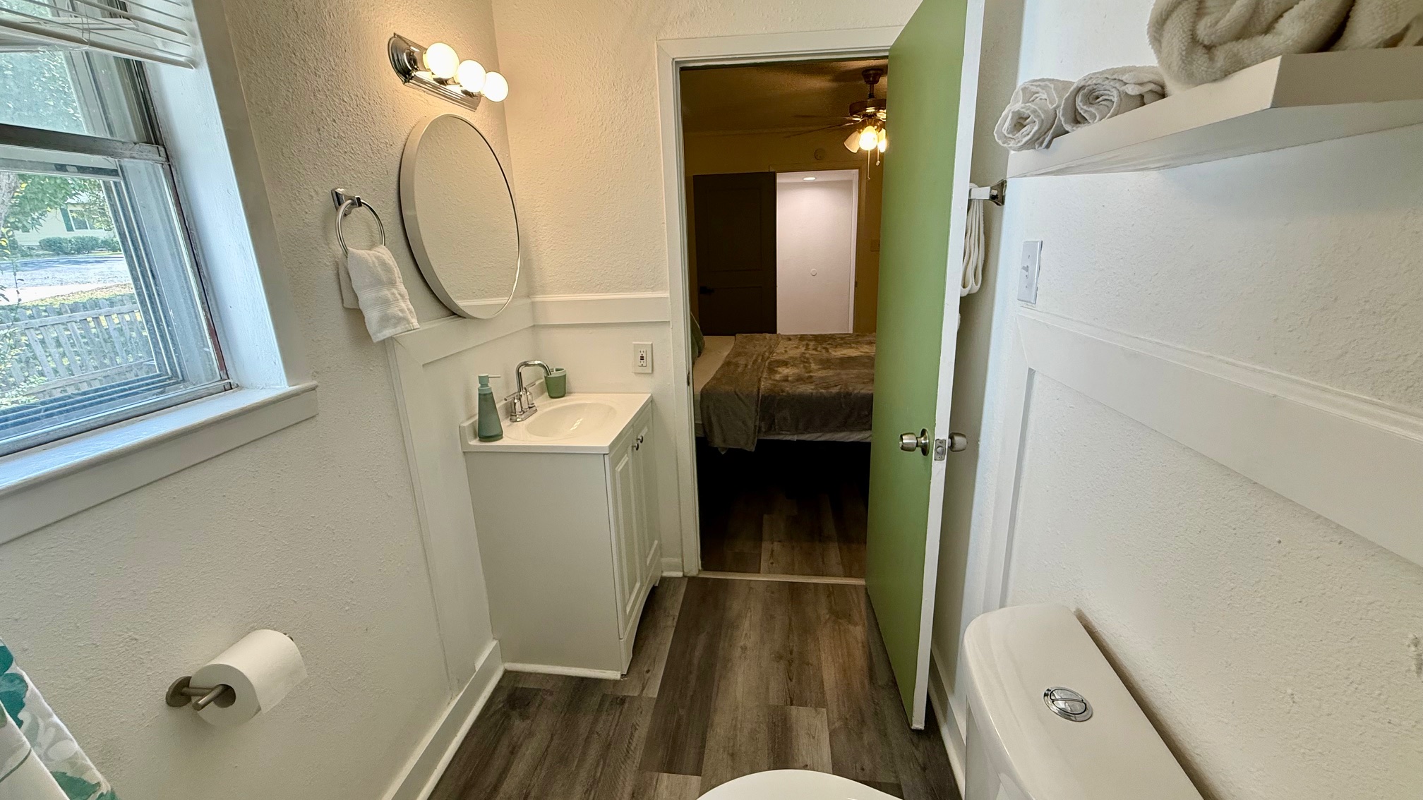 1802 East University Avenue, Unit A Georgetown, TX 78626 - Photo 17 of 23 Half bathroom with a textured wall, vanity, connected bathroom, dark wood finished floors, and a ceiling fan