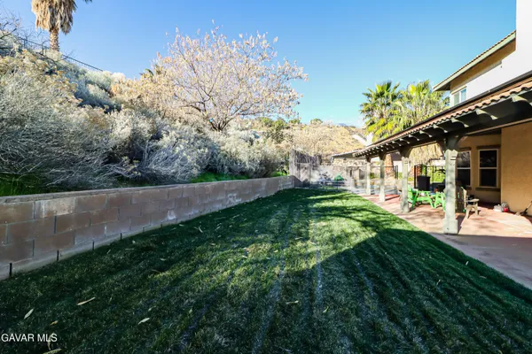 a view of a house with backyard swimming pool and sitting area