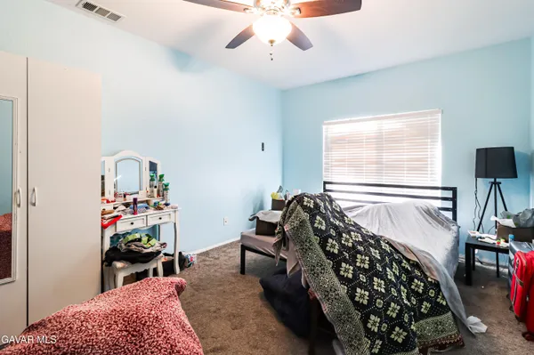 a bed room with a bed and a chandelier