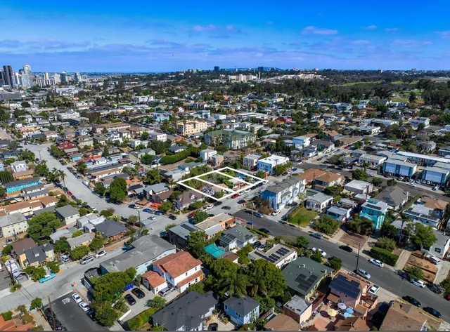 an aerial view of residential building with green space