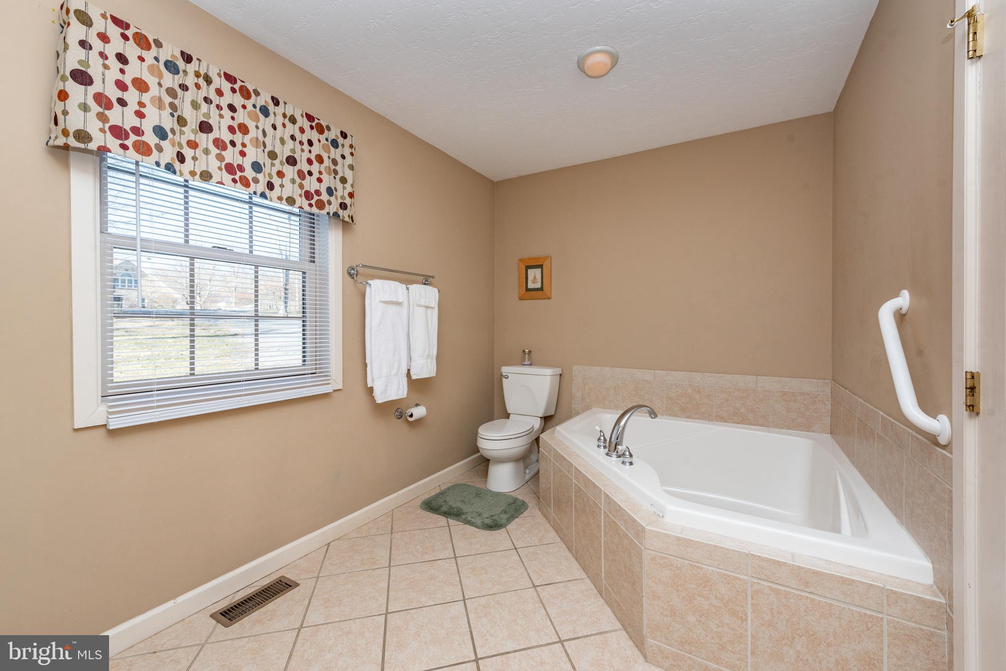 2828 Glendale Road Swanton, MD 21561 - Photo 23 of 78 a bathroom with a bathtub and a window