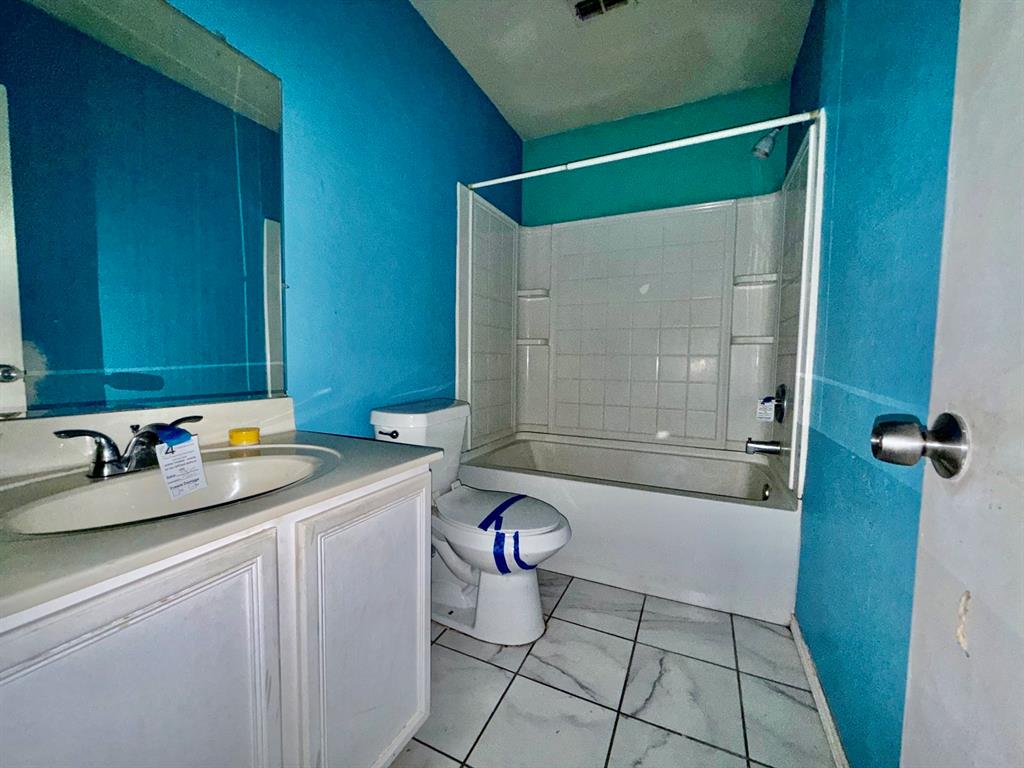 1144 Switchgrass Lane Crowley, TX 76036 - Photo 9 of 17 a bathroom with a granite countertop sink a mirror and shower
