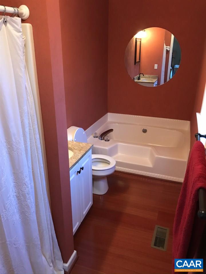 6845 Cabell Road Howardsville, VA 24562 - Photo 23 of 49 a bathroom with a toilet a sink a tub and mirror