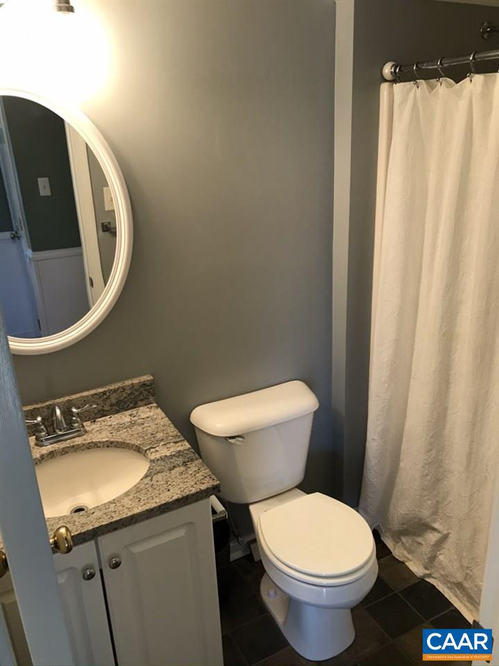 6845 Cabell Road Howardsville, VA 24562 - Photo 26 of 49 a white toilet sitting next to a bathroom sink