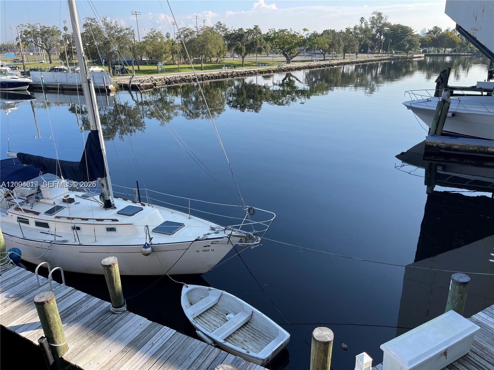 2415 Northwest 16th St Road, Unit 102 Miami, FL 33125 - Photo 18 of 19 a view of a lake with tables and chairs