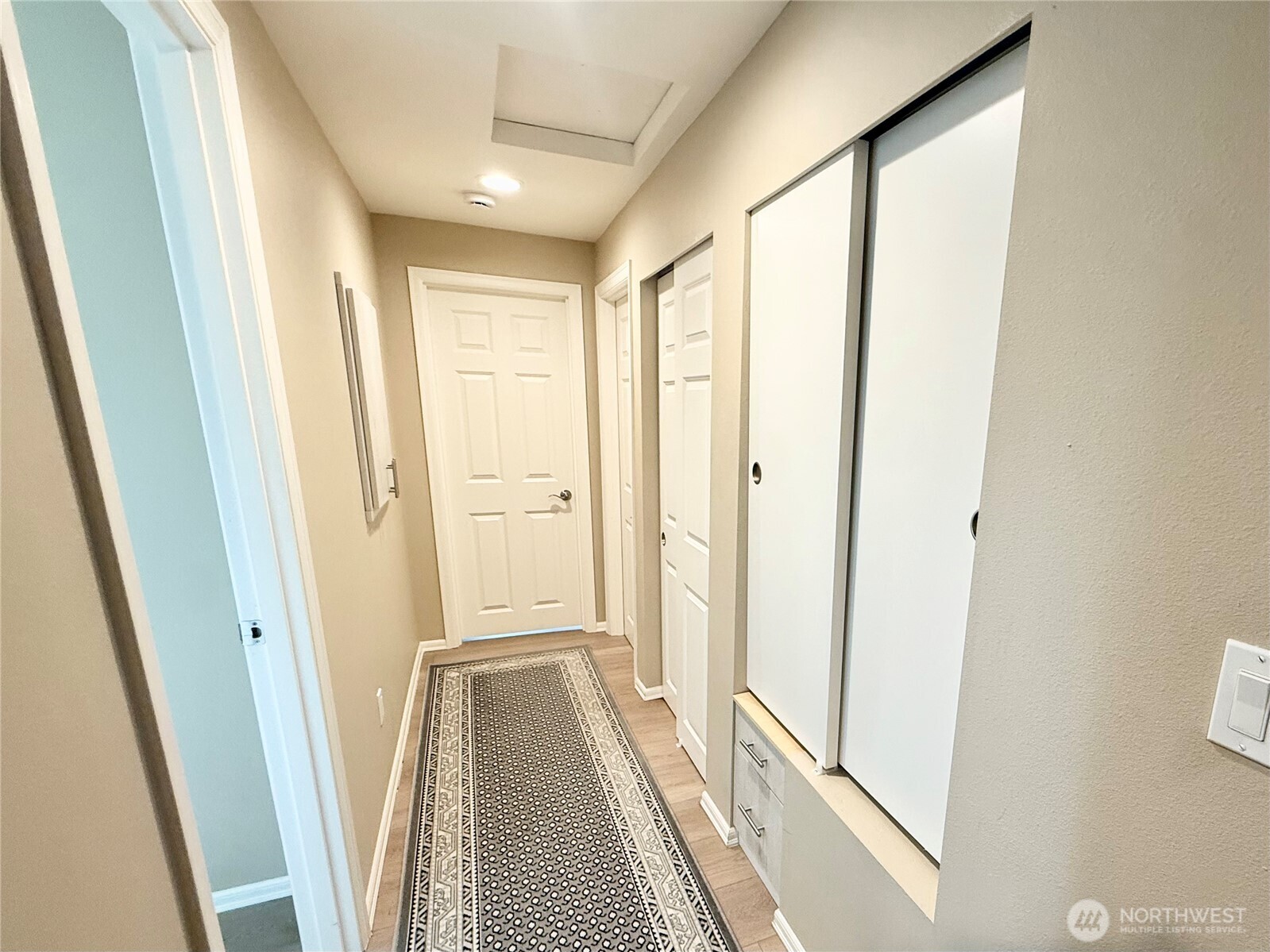 11049 18th Avenue Southwest Seattle, WA 98146 - Photo 19 of 40 a view of a hallway with wooden floor and staircase