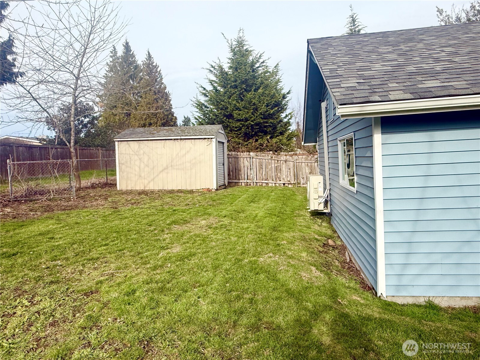 11049 18th Avenue Southwest Seattle, WA 98146 - Photo 33 of 40 a view of a backyard with barn and wooden fence
