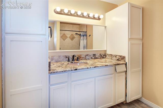 17879 Pinon Park Road Peyton, CO 80831 - Photo 13 of 26 Granite counter, tile shower and lots of storage in the Master Bathroom!