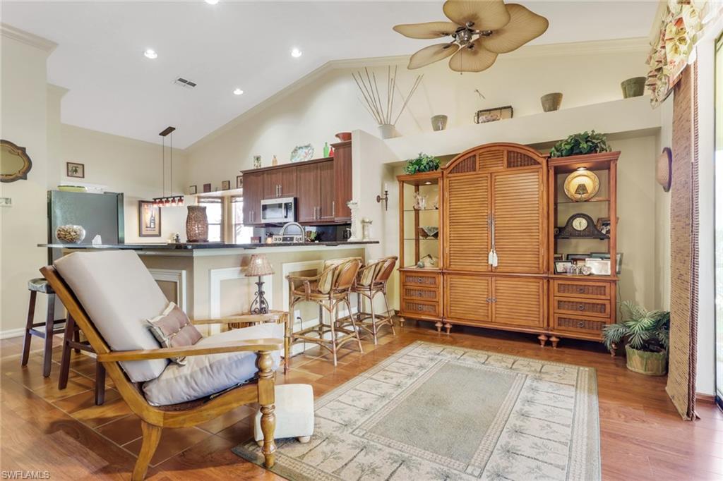 478 Countryside Drive Naples, FL 34104 - Photo 13 of 46 a kitchen with stainless steel appliances kitchen island granite countertop a refrigerator and microwave