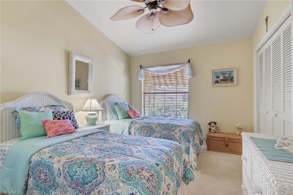 478 Countryside Drive Naples, FL 34104 - Photo 19 of 46 a bedroom with a bed and a chandelier