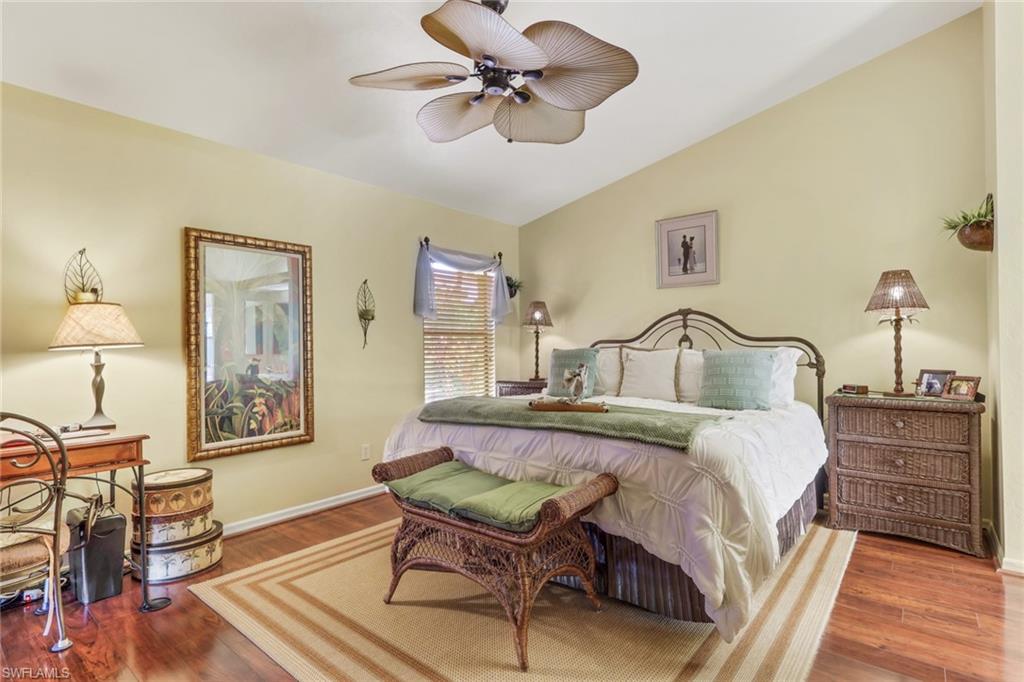 478 Countryside Drive Naples, FL 34104 - Photo 22 of 46 a bedroom with bed and a chandelier