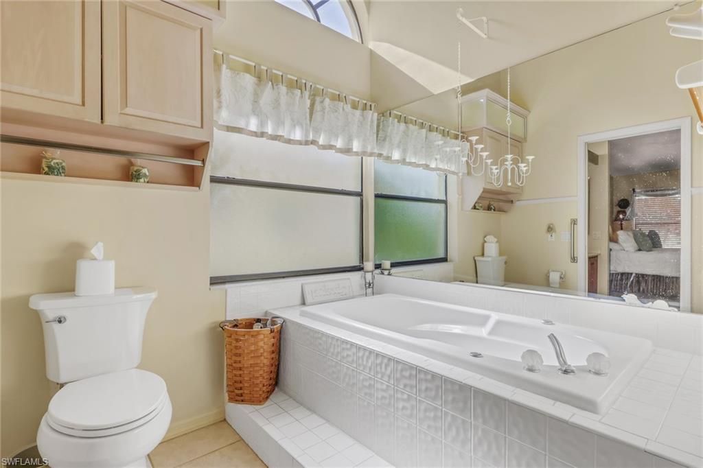 478 Countryside Drive Naples, FL 34104 - Photo 25 of 46 a bathroom with a sink and mirror