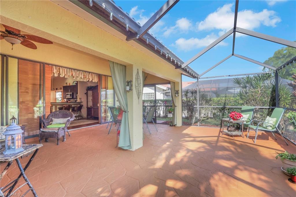 478 Countryside Drive Naples, FL 34104 - Photo 31 of 46 a view of a patio with a table and chairs under an umbrella