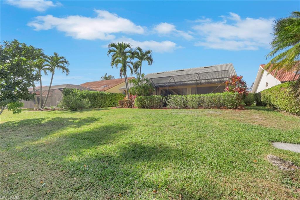 478 Countryside Drive Naples, FL 34104 - Photo 32 of 46 a view of a garden with a building in the background