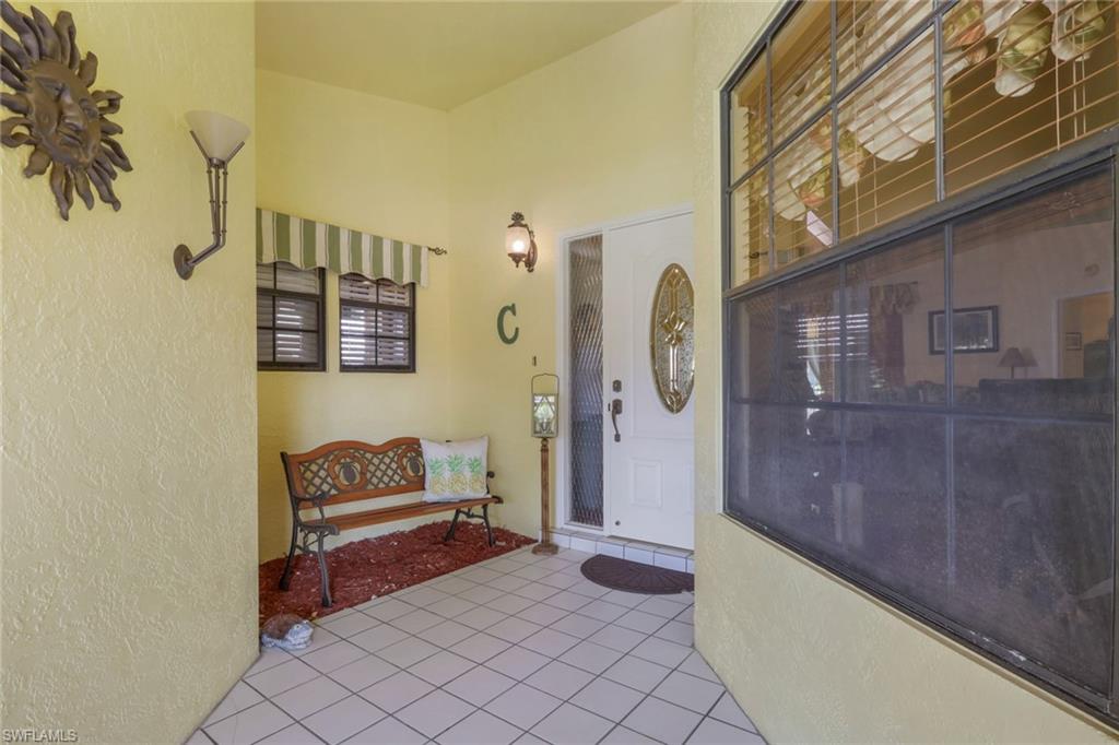 478 Countryside Drive Naples, FL 34104 - Photo 4 of 46 a living room with furniture and a rug