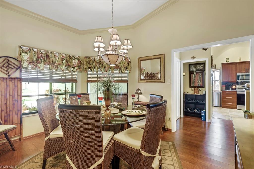 478 Countryside Drive Naples, FL 34104 - Photo 6 of 46 a view of a dining room with furniture wooden floor and chandelier