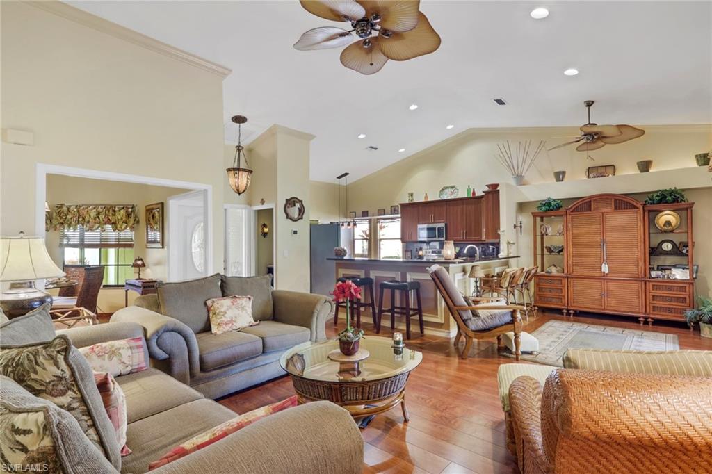 478 Countryside Drive Naples, FL 34104 - Photo 9 of 46 a living room with furniture kitchen view and a large window