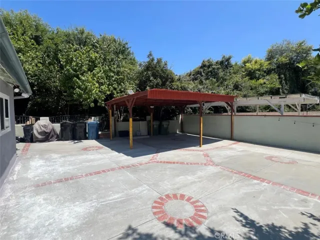 a backyard of a house with table and chairs