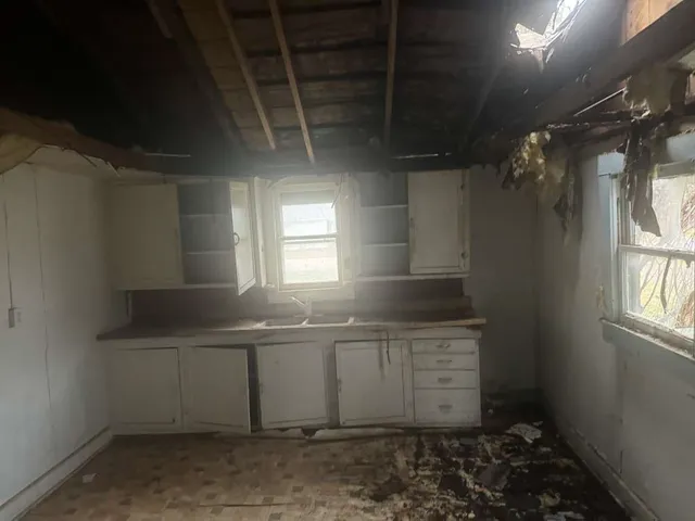 a kitchen with a sink and cabinets