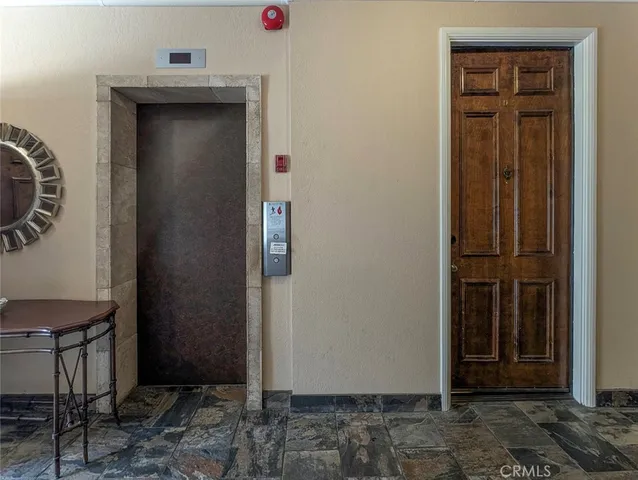 a view of a livingroom with wooden floor and a fireplace