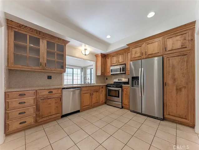 a kitchen with stainless steel appliances granite countertop a stove and a sink
