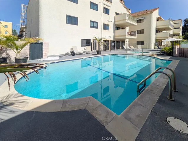 a view of a swimming pool with outdoor seating