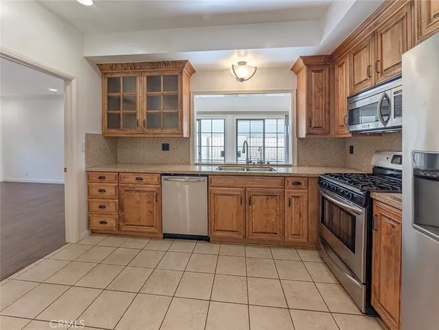 a bathroom with a sink mirror a washer and dryer