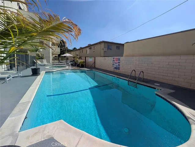 a front view of a building with cars parked