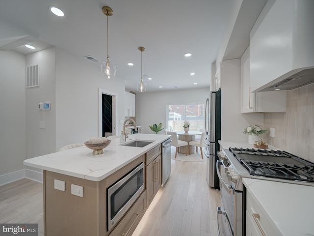 a kitchen with counter top space a sink stove and refrigerator