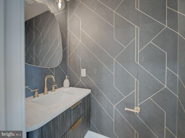 a bathroom with a sink toilet and mirror