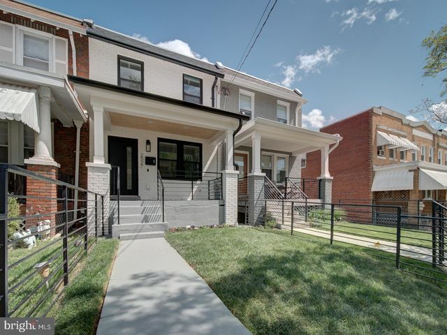 a front view of a building with a garden