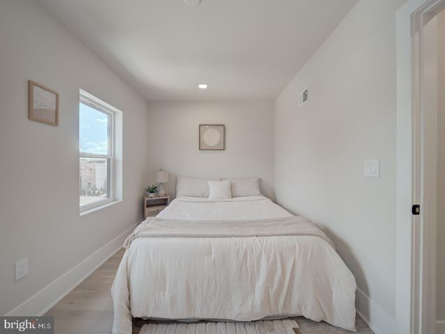 a bed room with a bed and a night stand