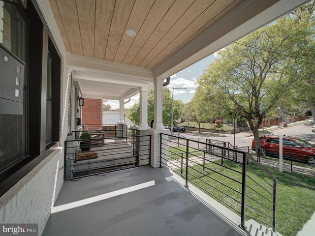 a view of a porch with wooden floor and fence
