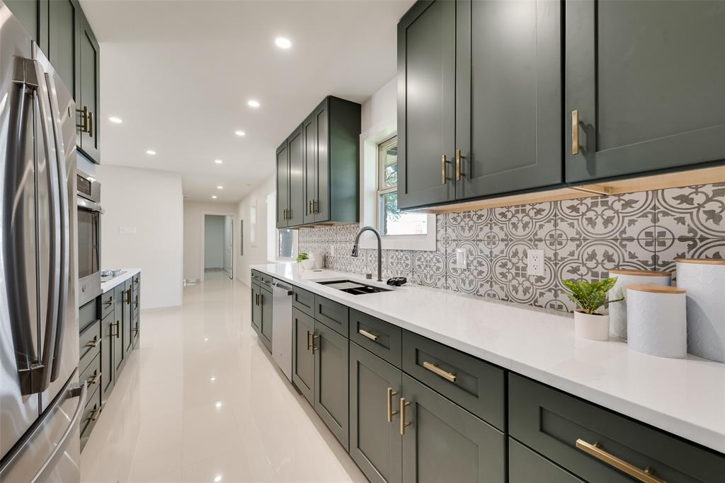 3106 Sharpview Lane Dallas, TX 75228 - Photo 17 of 31 a large kitchen with stainless steel appliances a sink dishwasher a stove and a wooden floor