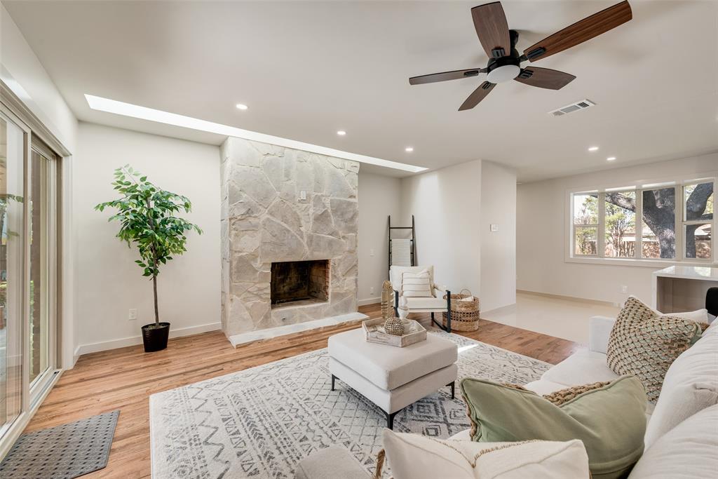 3106 Sharpview Lane Dallas, TX 75228 - Photo 10 of 31 a living room with furniture a fireplace and a potted plant