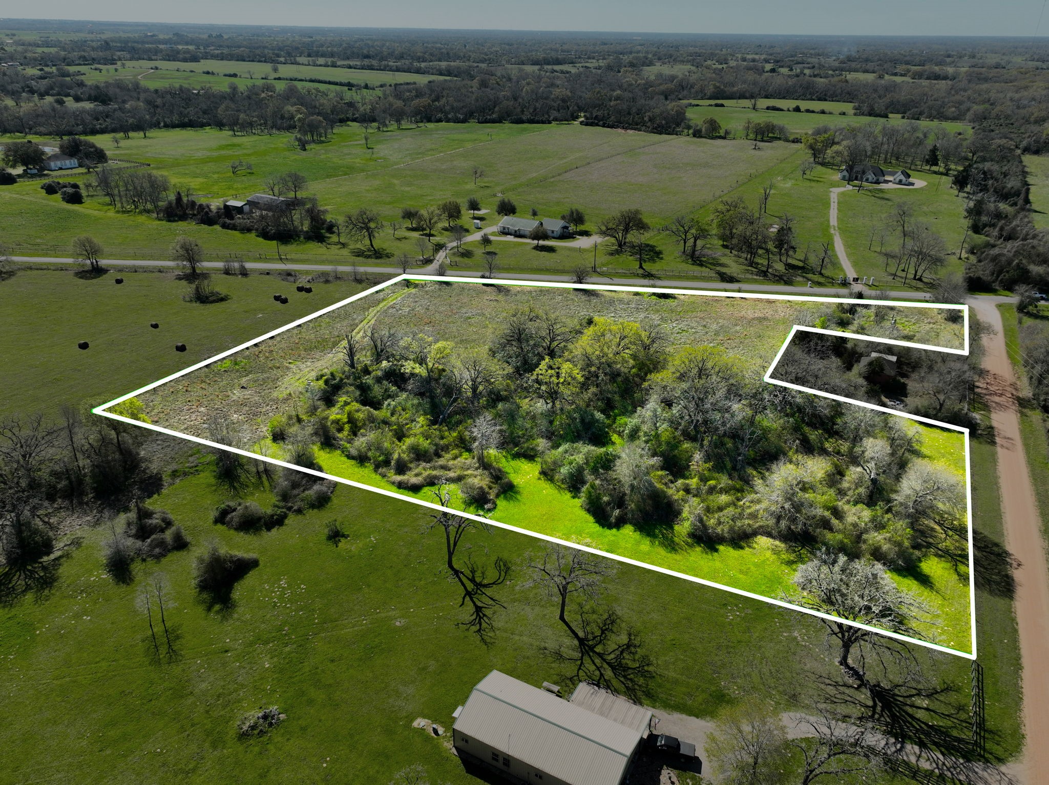 21100 Telephone Road Hempstead, TX 77445 - Photo 32 of 34 an aerial view of a golf course with a lake view