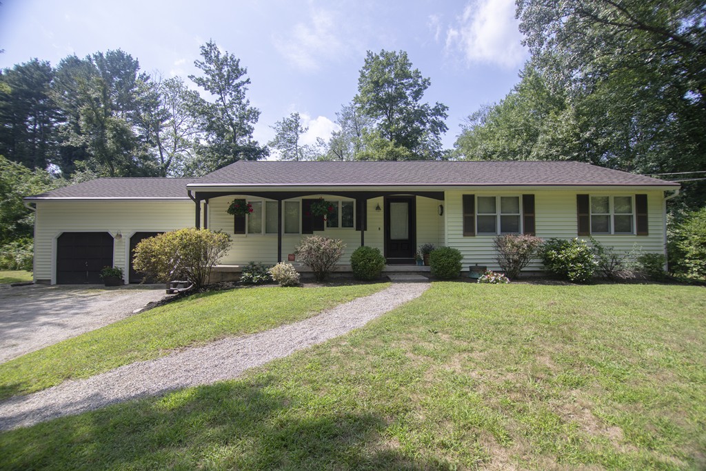 a front view of house with yard and green space