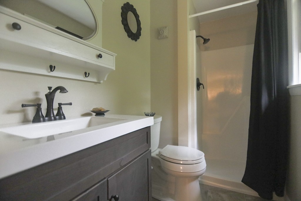 107 Park Road Chelmsford, MA 01824 - Photo 11 of 17 a bathroom with a sink a toilet and shower