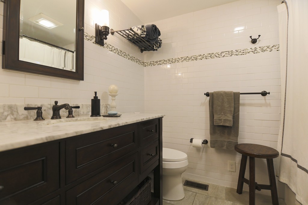 107 Park Road Chelmsford, MA 01824 - Photo 14 of 17 a spacious bathroom with a granite countertop sink a toilet and a mirror