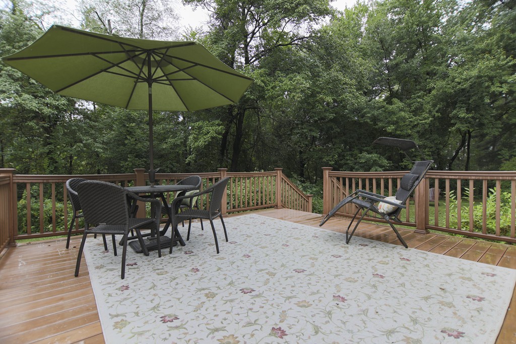 107 Park Road Chelmsford, MA 01824 - Photo 16 of 17 a view of a roof deck with table and chairs under an umbrella