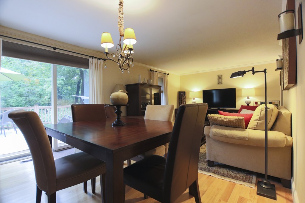 107 Park Road Chelmsford, MA 01824 - Photo 5 of 17 a view of a dining room with furniture a chandelier and large windows