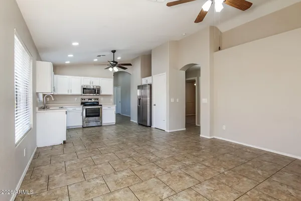 a view of a kitchen with a sink and a refrigerator