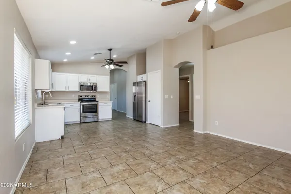 a view of a kitchen with a sink and a refrigerator